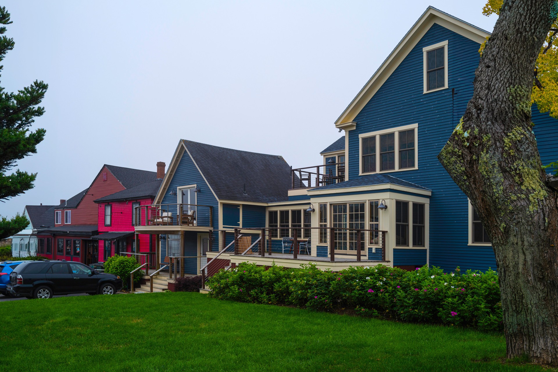 Vibrant buildings and garden in a small town shopping mall in the coastal village of New England. Charming summer travel landscape of Boothbay in Lincoln County, Maine.