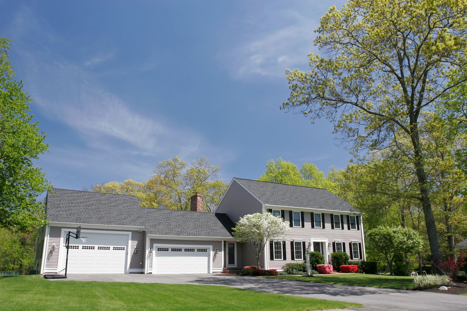 Cream colored single family house with two garages